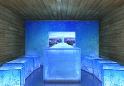 KLAFS ICE LOUNGE with ATMOSPHERE single screen, STALAGMITE ice fountain, acrylic glass seating cube, reclaimed wood wall and ceiling.