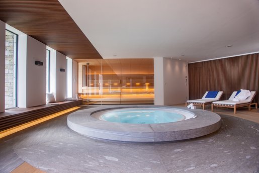In the center of the wellness oasis is the three-meter jacuzzi made of high-quality Vals quartzite
